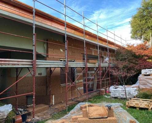 a building with scaffolding and pallets